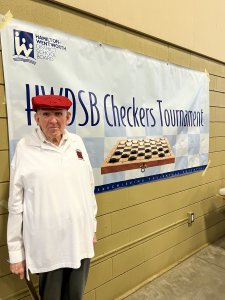 Man in front of checkers sign