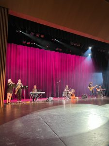 Students playing music on stage