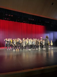 Elementary choir singing on stage