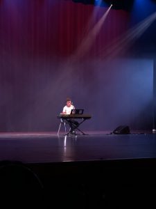 Student singing on stage