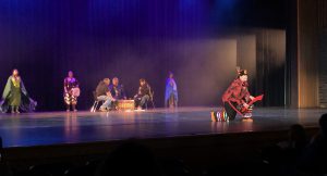 Students performing traditional Indigenous dance on stage