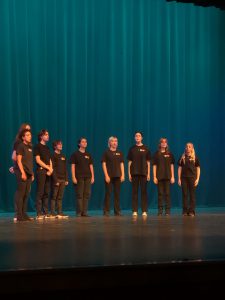 Students singing on stage