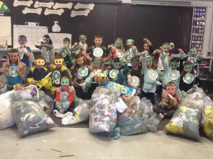 Earth Warriors sitting and standing with garbage bags