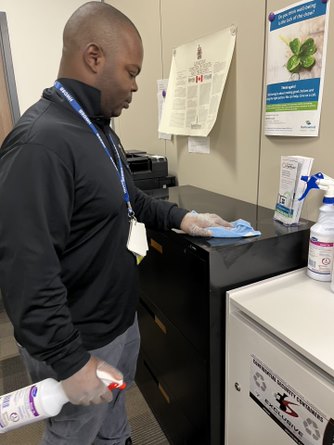 Worker cleaning surfaces