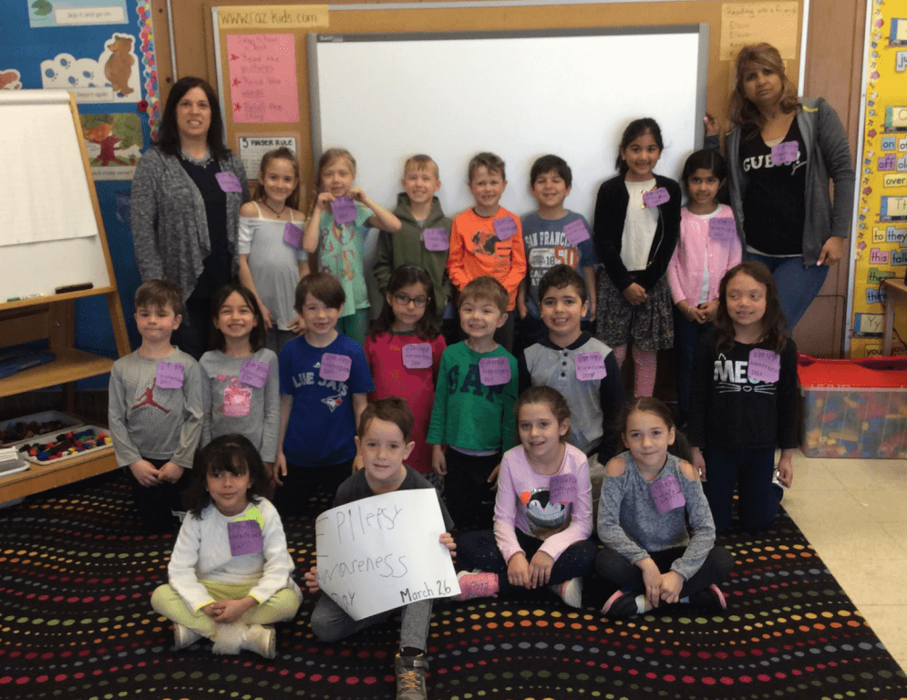 children posing with 2 teachers