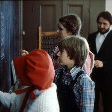 students writing on chalk board