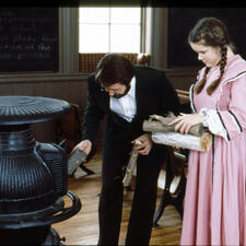 Student and teacher around stove