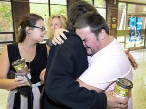Hamilton Spectator Photo: Shane Tabone hugs dad Tim who he saved with CPR he learned at school. Shane's sister, Tiffany, left, and mother, Sherry MacKinnon, behind, look on happily.