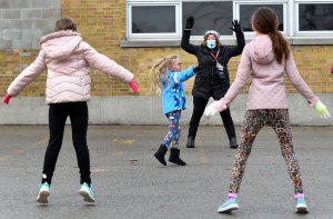 Jennifer Vince at Rosedale Elementary School leads Mrs. Davies Grade 2/3 split class through an outdoor phys-ed class Monday morning. Barry Gray/Hamilton Spectator