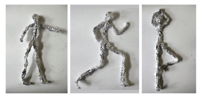 Image of three foil figures created in the style of Giacometti.