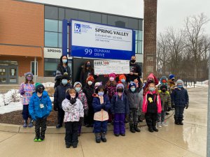 Spring Valley Elementary School staff and students receiving prize from firefighter. 