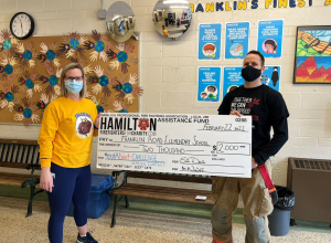 Franklin Road Elementary School staff member receiving prize from firefighter. 