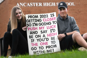students with promposal sign