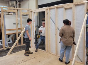 Students erect tiny home.