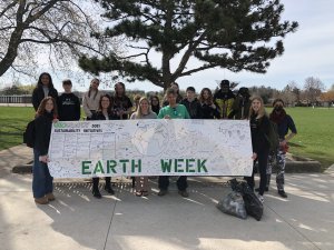 Students holding up Earth Week sign