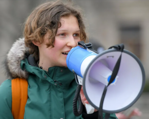 Jordyn Boyer, youth climate activist, Eco Ninja from Westmount Secondary School and organizer of the event, speaks to the crowd