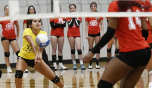 Ada Calcagni, from St. John Henry Newman, bumps a serve in the junior game