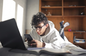 teen studying on bed