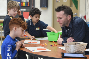 educator helping student with math in spectator photo